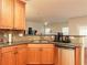 Well-equipped kitchen with wooden cabinets, granite countertops, and stainless steel dishwasher at 5888 Cobblestone Creek Cir, Mableton, GA 30126