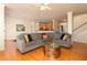 Spacious living room with hardwood floors, comfortable sofa, and open access to the kitchen at 5888 Cobblestone Creek Cir, Mableton, GA 30126