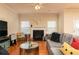 Cozy living room with hardwood floors, fireplace, comfortable seating, and ample natural light at 5888 Cobblestone Creek Cir, Mableton, GA 30126