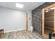 Spa room featuring sauna, stone accent wall, and wood-look floors at 5888 Cobblestone Creek Cir, Mableton, GA 30126