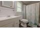 The clean bathroom has a white vanity, mirror, toilet, and a shower with a decorative curtain at 2497 Edwards Nw Dr, Atlanta, GA 30318
