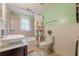 Bright bathroom featuring a vessel sink, tiled shower and tub combination, and floral shower curtain at 2497 Edwards Nw Dr, Atlanta, GA 30318