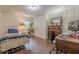 A cozy bedroom with hardwood floors, a bed, a desk and chair, and a closet at 2497 Edwards Nw Dr, Atlanta, GA 30318