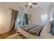 This bedroom features hardwood floors, a ceiling fan, and doors leading to the deck at 2497 Edwards Nw Dr, Atlanta, GA 30318