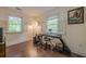 Bright bedroom with hardwood floors, shuttered windows, and a music setup, providing a creative and relaxing space at 2497 Edwards Nw Dr, Atlanta, GA 30318