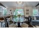 Bright dining area with a glass table, connecting to a cozy living space and a well-equipped kitchen at 2497 Edwards Nw Dr, Atlanta, GA 30318