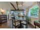 Open dining area with wooden beams, adjacent to a modern kitchen and cozy seating area at 2497 Edwards Nw Dr, Atlanta, GA 30318