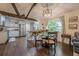 Charming dining area features a glass table, wooden chairs, and stylish lighting fixture at 2497 Edwards Nw Dr, Atlanta, GA 30318