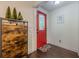 Warm entryway featuring a stylish cabinet, bright red door and hardwood flooring at 2497 Edwards Nw Dr, Atlanta, GA 30318