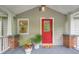 Inviting front porch featuring a bright red door and potted plants for a warm welcome at 2497 Edwards Nw Dr, Atlanta, GA 30318