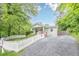 Charming home with manicured lawn, bright flowers, private driveway, and classic white picket fence at 2497 Edwards Nw Dr, Atlanta, GA 30318