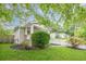 Landscaped yard with a lush garden, a manicured lawn, mature trees, and a classic white picket fence at 2497 Edwards Nw Dr, Atlanta, GA 30318