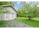 View of the property's one car garage and lawn at 2497 Edwards Nw Dr, Atlanta, GA 30318