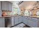 Spacious kitchen features a stainless steel dishwasher, granite countertops, and a large sink with a window view at 2497 Edwards Nw Dr, Atlanta, GA 30318