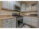 Well-appointed kitchen boasts stainless steel appliances, granite countertops, and stylish backsplash, creating a modern culinary space at 2497 Edwards Nw Dr, Atlanta, GA 30318