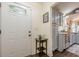 Welcoming entrance with a view of the kitchen featuring gray cabinets, stainless appliances, and granite countertops at 2497 Edwards Nw Dr, Atlanta, GA 30318