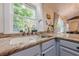 Bright kitchen features granite countertops, a large sink with a window overlooking a treehouse, and modern appliances at 2497 Edwards Nw Dr, Atlanta, GA 30318