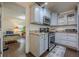Charming kitchen features blue cabinets, stainless steel appliances, and an adjacent bedroom view, creating a cozy atmosphere at 2497 Edwards Nw Dr, Atlanta, GA 30318