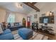 Stylish living room with a vaulted ceiling, highlighted by exposed wood beams and a vibrant red door at 2497 Edwards Nw Dr, Atlanta, GA 30318