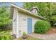 Backside view of building exterior with a light blue door and stone paver walkway at 2497 Edwards Nw Dr, Atlanta, GA 30318