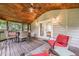 Cozy covered back porch with comfortable seating, an outdoor table, and beautiful wood paneled ceiling at 2497 Edwards Nw Dr, Atlanta, GA 30318
