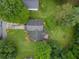 Aerial view of a home with a dark roof, surrounded by lush greenery and a well-maintained lawn at 4896 Muirwood Dr, Powder Springs, GA 30127