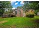 Backyard with lush green lawn and mature trees, showing exterior of home at 4896 Muirwood Dr, Powder Springs, GA 30127