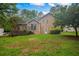 A spacious backyard features a wooden deck, green grass, and mature trees, offering a private outdoor space at 4896 Muirwood Dr, Powder Springs, GA 30127