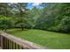 Picture of a well-maintained yard with green grass and tall trees at 4896 Muirwood Dr, Powder Springs, GA 30127