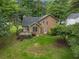 Aerial view of a home featuring a backyard deck surrounded by trees and lush greenery at 4896 Muirwood Dr, Powder Springs, GA 30127