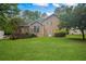 Backyard view of lawn, trees, deck and rear exterior of the home at 4896 Muirwood Dr, Powder Springs, GA 30127