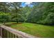 Picture of a well-maintained yard with green grass and tall trees at 4896 Muirwood Dr, Powder Springs, GA 30127