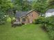 Aerial view of a home featuring a backyard deck surrounded by trees and lush greenery at 4896 Muirwood Dr, Powder Springs, GA 30127