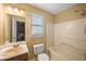 Bathroom featuring a vanity, mirror, toilet and tub with shower head at 4896 Muirwood Dr, Powder Springs, GA 30127