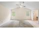 Spacious carpeted bedroom with vaulted ceiling, ceiling fan and natural light at 4896 Muirwood Dr, Powder Springs, GA 30127