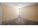 Carpeted bedroom with neutral walls and a window offering natural light at 4896 Muirwood Dr, Powder Springs, GA 30127