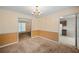 Traditional dining room featuring a chandelier and views to the kitchen and other rooms at 4896 Muirwood Dr, Powder Springs, GA 30127
