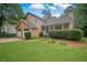 Charming two-story home with a two-car garage and inviting front porch surrounded by greenery at 4896 Muirwood Dr, Powder Springs, GA 30127