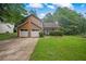 Well-maintained two-story home with attached garage, landscaped front yard, and welcoming entrance at 4896 Muirwood Dr, Powder Springs, GA 30127