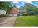 Well-maintained two-story home with attached garage, landscaped front yard, and welcoming entrance at 4896 Muirwood Dr, Powder Springs, GA 30127