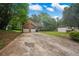 Two-story home featuring a two-car garage, driveway, and landscaped front yard on a sunny day at 4896 Muirwood Dr, Powder Springs, GA 30127