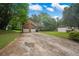 Two-story home featuring a two-car garage, driveway, and landscaped front yard on a sunny day at 4896 Muirwood Dr, Powder Springs, GA 30127