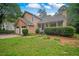 Charming two-story home with a two-car garage and inviting front porch surrounded by greenery at 4896 Muirwood Dr, Powder Springs, GA 30127