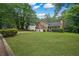 Charming two-story home with a well-manicured lawn and mature trees in a peaceful setting at 4896 Muirwood Dr, Powder Springs, GA 30127