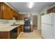 Efficient kitchen featuring neutral counters, tile flooring, and wood cabinets at 4896 Muirwood Dr, Powder Springs, GA 30127