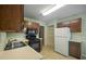 Well-lit kitchen area featuring neutral counters, tile flooring, and wood cabinets at 4896 Muirwood Dr, Powder Springs, GA 30127