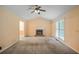 Cozy living room with vaulted ceiling, carpet floors, and a classic fireplace centerpiece at 4896 Muirwood Dr, Powder Springs, GA 30127