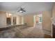 Living room with staircase, fireplace, carpet, and a peek into the dining area at 4896 Muirwood Dr, Powder Springs, GA 30127