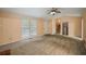 Large living room with vaulted ceiling, carpet floors, staircase, and double entry doors at 4896 Muirwood Dr, Powder Springs, GA 30127