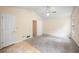 Carpeted Primary bedroom with vaulted ceiling, ceiling fan and doors to closet and bathroom at 4896 Muirwood Dr, Powder Springs, GA 30127